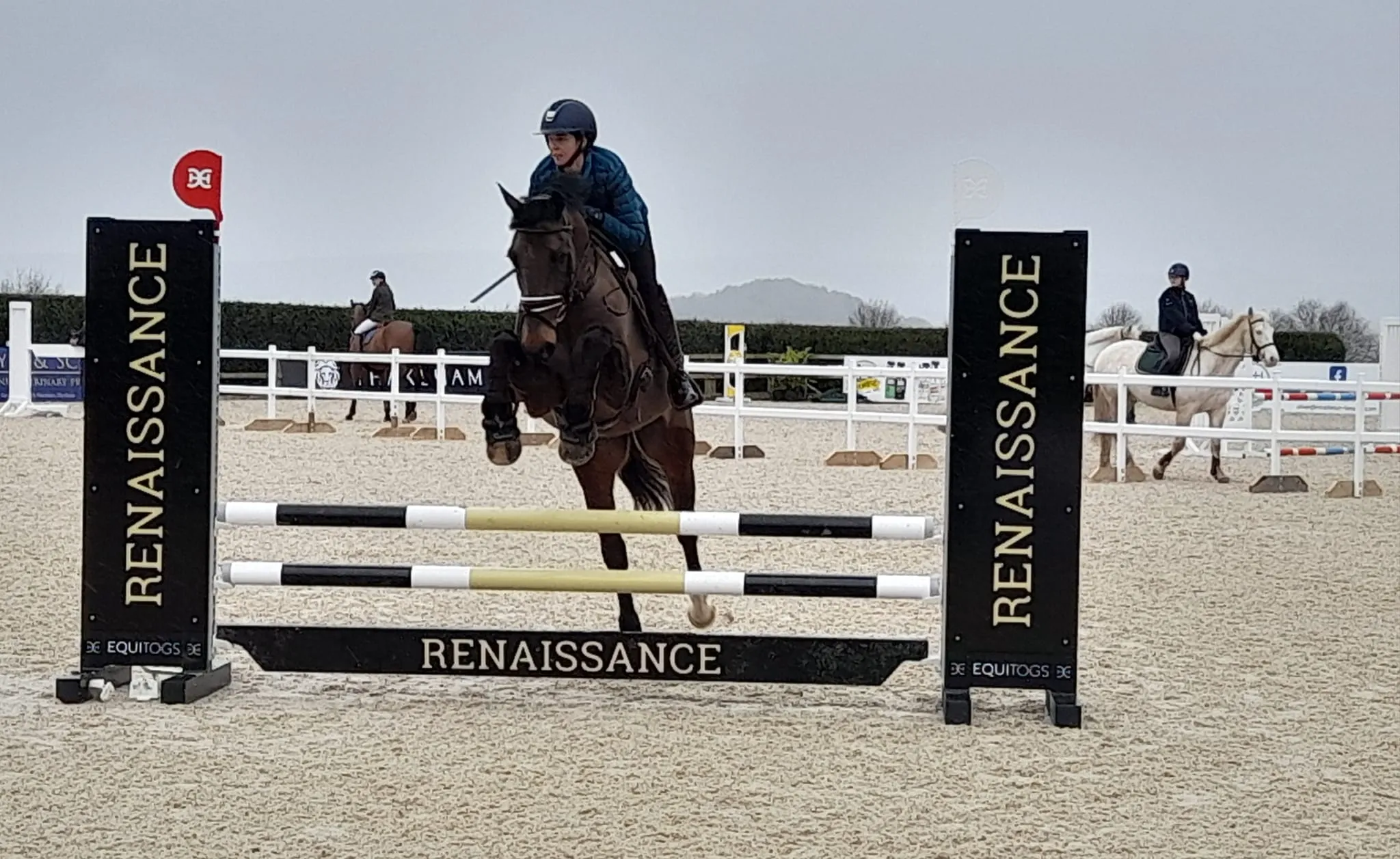 A person on a horse jumping over an obstacle.