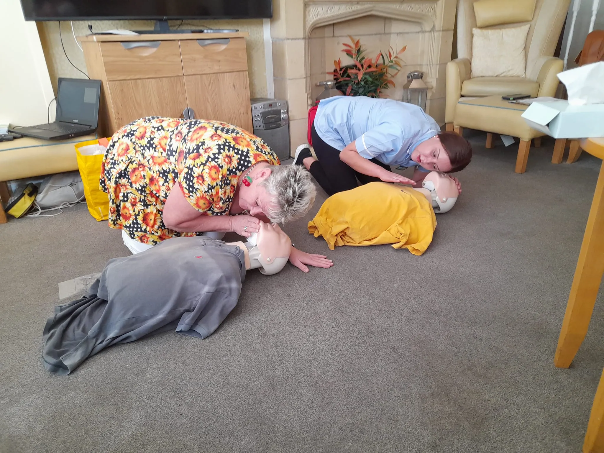A group of people laying on the floor in a living room.